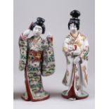 Two Japanese Kutani female Figures, Meiji Period, one with a fan, the other with a puppy, both