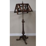 A Victorian rosewood telescopic Music Stand on carved tripod base, 4ft 6in H