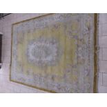 A large Chinese Carpet with scrolled floral design on a gold ground, 12ft x 9ft