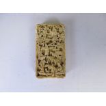 A 19th Century Chinese deep carved ivory Card Case depicting numerous figures in a landscape, 3 1/