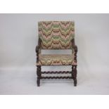 A 17th Century style carved open Armchair, broad padded square back and seat, acanthus carved