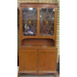 A 19th Century Sheraton style satinwood Cabinet with acorn pendant frieze above pair of astragal