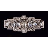 An Art Deco Diamond Brooch having stepped rectangular openwork plaque millegrain-set oval rose-cut