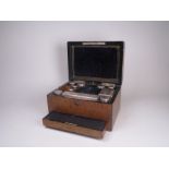 A Victorian burr walnut Vanity Case with hinged cover containing silver covered glass Jars and