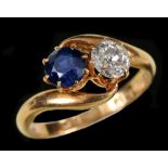 A Sapphire and Diamond crossover Ring claw-set round sapphire and old-cut diamond in 18ct gold,