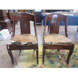 A Set of four Regency mahogany bar back Dining Chairs with drop in seats on outswept sabre front