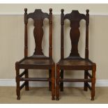 A pair of 17th Century Welsh Side Chairs with turned finials, solid vase splats, solid seats on