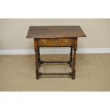 An antique oak Side Table fitted frieze drawer on baluster turned and square legs united by turned