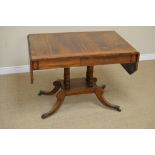 A late Regency rosewood and satinwood-crossbanded Sofa Table, the top with canted corners, the