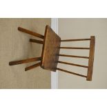 An antique Welsh primitive Chair with stick back, solid seat on splayed legs