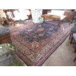 A bordered Tabriz Carpet with floral design on a blue ground, 13ft 9in x 9ft 11in