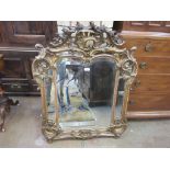 A 19th Century Rococo style gilded Wall Mirror, the pierced scrolled crest above a divided