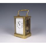 A brass cased Carriage Clock the white enamel dial with roman numerals, 5in H