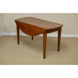 A 19th Century oval fruitwood Table with small folding leaves fitted frieze drawer on squared