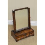 A Georgian walnut Dressing Mirror having shaped rectangular plate with gilt slip, acorn finials, the