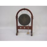 A Gothic Revival oak Hall Gong, the arched frame on chamfered square uprighted quatrefoil pierced