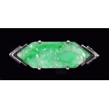 An Art Deco Jade Brooch set lozenge shaped carved stone in white gold, stamped 9ct