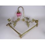An antique brass folding Wall Light, a pair of Regency style two branch Wall Lights, 11in W, and a