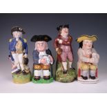 Four 19th Century pottery Toby Jugs comprising a jug modelled as Lord Nelson, 11 1/2 in, a seated