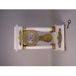 An early 19th Century Portico Clock in white marble and fire gilded bronze attributed to Raingo with