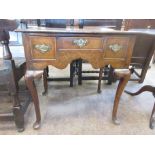 An antique oak Lowboy fitted three frieze drawers on four cabriole supports, 2ft 3in W