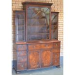 A Georgian mahogany Breakfront Secretaire Bookcase with dentil and gouge carved friezes above