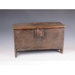 A 17th Century oak Coffer of small proportions with floral and chip carved front panel, iron