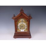 A 19th Century style mahogany cased Bracket Clock with carved chamfered corners, bevelled glass side