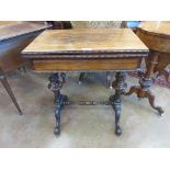 An early Victorian rosewood Card/Work Table with rectangular fold-over top enclosing baize