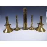 A pair of early 19th Century brass Candlesticks with ejectors on circular bases, another pair with