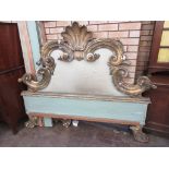 A 19th Century parcel gilt gesso rococo Bed, the large partially upholstered headboard with