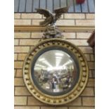 A Regency giltwood Convex Mirror, the eagle and rockwork surmount above a moulded circular frame