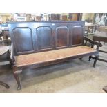 An 18th Century oak Settle with fielded four panel back on cabriole front supports and pad feet, 6ft