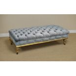 A 19th Century giltwood large Stool with later blue velvet button upholstery, raised on lobed