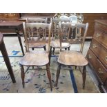 A set of four 19th Century gothic style Kitchen Chairs, with spindle backs on turned supports and