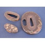 Three items of Japanese Sword Furniture including an oval Tsuba for wakizashi, a fuchi and