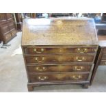 A Georgian oak Bureau with fited interior above four long graduated drawers on bracket feet, 3ft