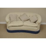 A kidney shape Settee with cream button upholstery