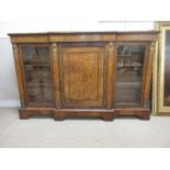 A Victorian walnut and gilt metal mounted breakfront Bookcase, marquetry inlaid frieze above