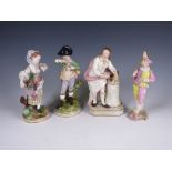 A pair of Continental Figures, boy and girl with fruit and flowers on round bases, 9in, a Figure