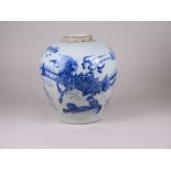 A Chinese blue and white Jar, Transitional c.1640, painted with Qilin and Bixie, mountains beneath