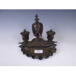 A 19th Century bronze Inkstand with central lidded urn with Egyptian mask flanked by pair of