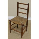 A 19th Century Child's Chair in ash with bobbin turned rail back, rush seat on simulated bamboo