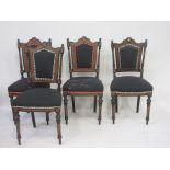 A set of four late Victorian ebonised and amboyna marquetry Side Chairs, with shaped padded backs