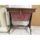 A 19th Century rosewood Sewing Table fitted frieze drawer above silk box base on six turned supports