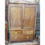 A late Georgian mahogany Linen Press with carved quarter roundels to the cornice above pair of solid