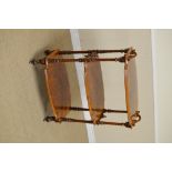 A Victorian walnut three tier Whatnot of shaped rectanguar form on fluted turned supports,