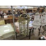 A 19th Century brass cylindrical Hall Lantern, the arched top over a pierced frieze with urn