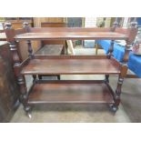 A 19th Century mahogany three tier Buffet on turned and fluted supports and ceramic casters 3ft