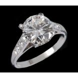 A Diamond single stone Ring claw-set brilliant-cut stone, 2.22cts, between trios of stones pavé-
